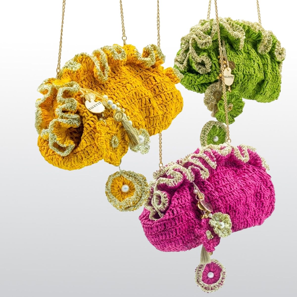 Three colorful crocheted  raffia bags by Palette by Rishma hanging against a white background - fete collection