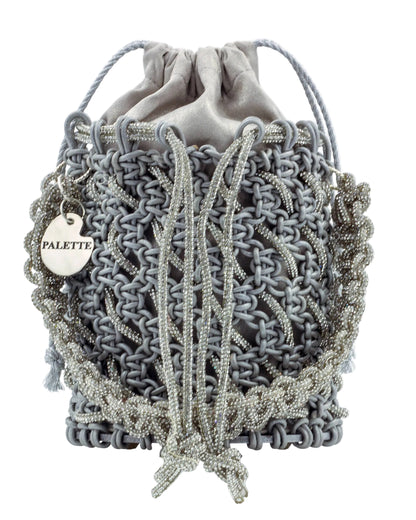 Close-up of hand-knotted macramé lattice and rhinestone detail on Palette by Rishma Sterling Bucket Bag