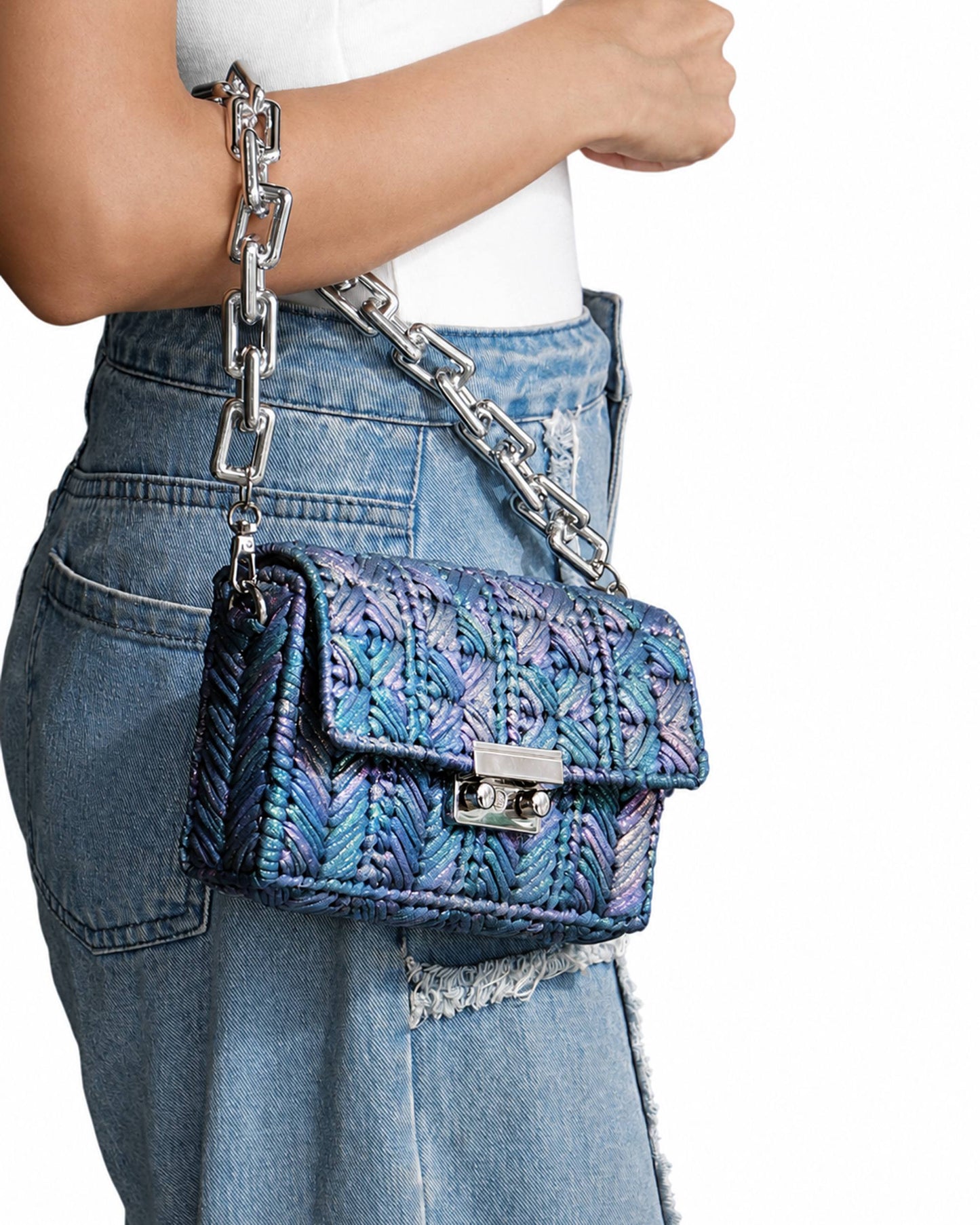 Palette by Rishma Merine Bag worn as a clutch — iridescent blue evening bag in use