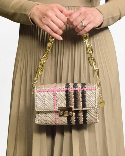Palette by Rishma Vesper Bag worn as a clutch — champagne, black, pink and rose gold evening bag in use